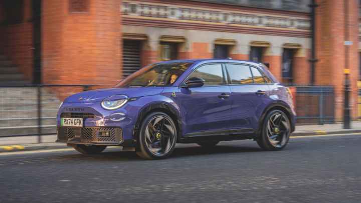 Blue Abarth parallel parked on the side of the road