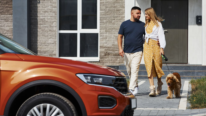 Couple Walking Dog to Car