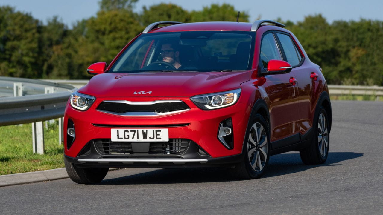 Red Kia Stonic driving on the road