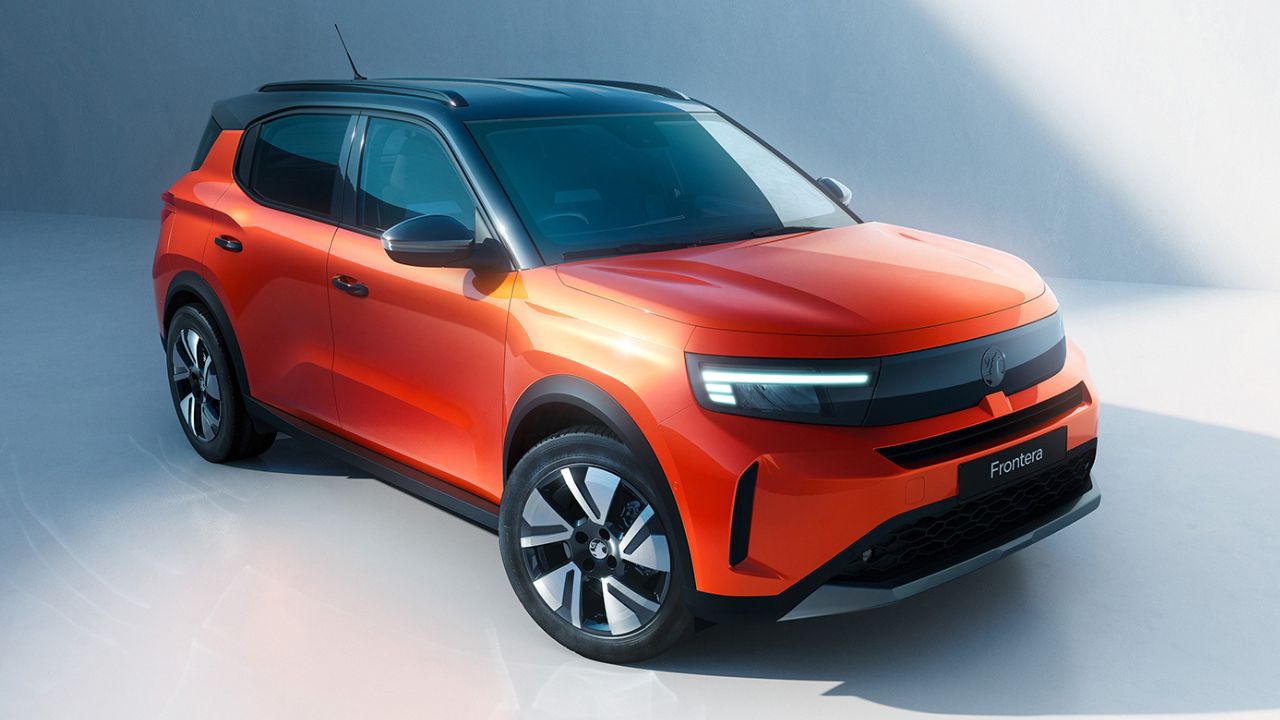 Orange Vauxhall Frontera parked in front of a white wall