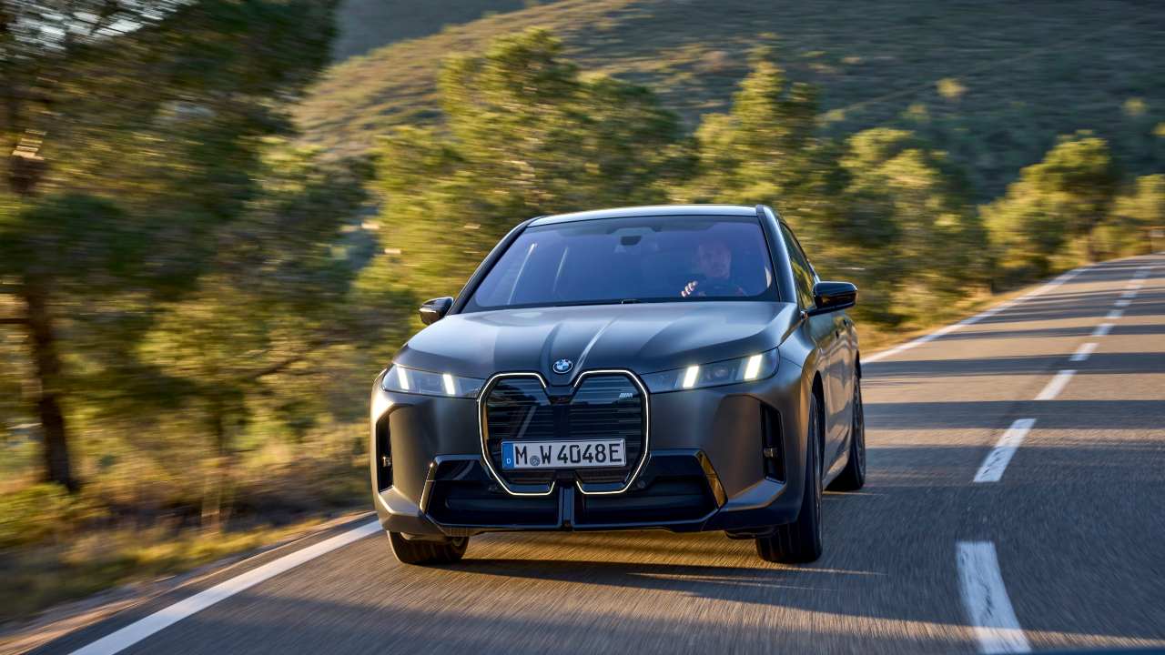 Black BMW IX driving front 