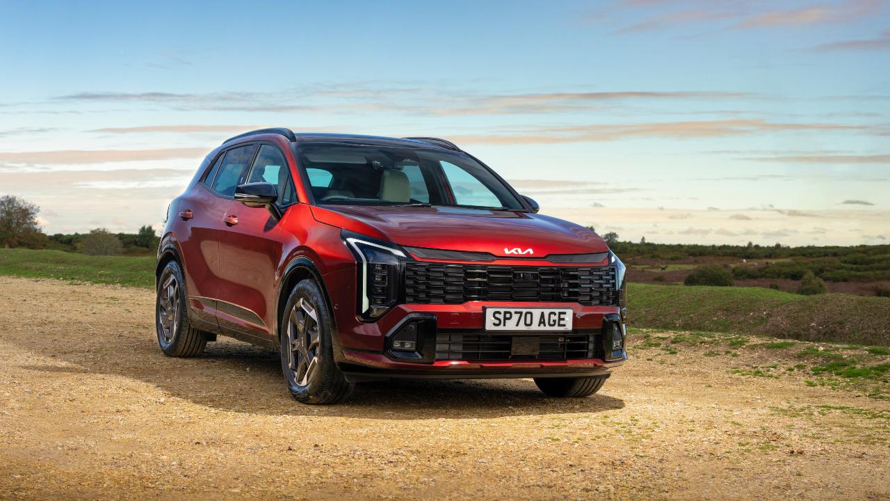Red Kia Sportage front left static