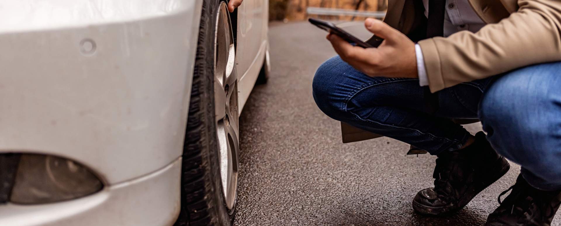 Man checking car wheel