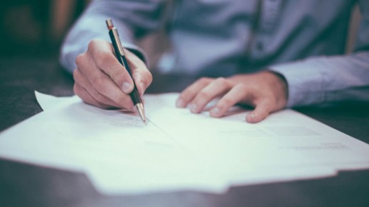 A man signing a contract