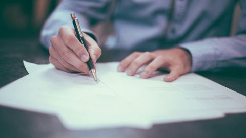 A man signing a contract