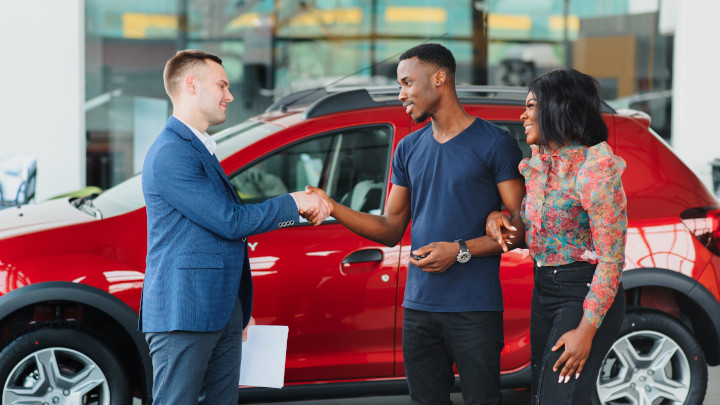Shaking Hands In Front of Car