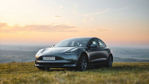 Tesla parked in the countryside