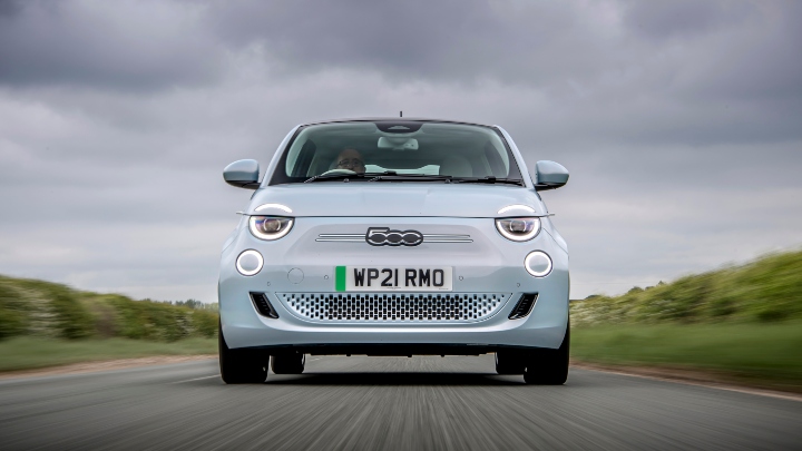 Blue Fiat 500e Exterior Front Driving Countryside