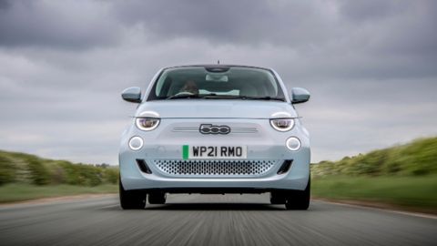 Pale blue Fiat 500 driving in the countryside