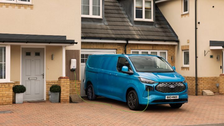 Ford Pro Power Promise. Electric transit parked on driveway.