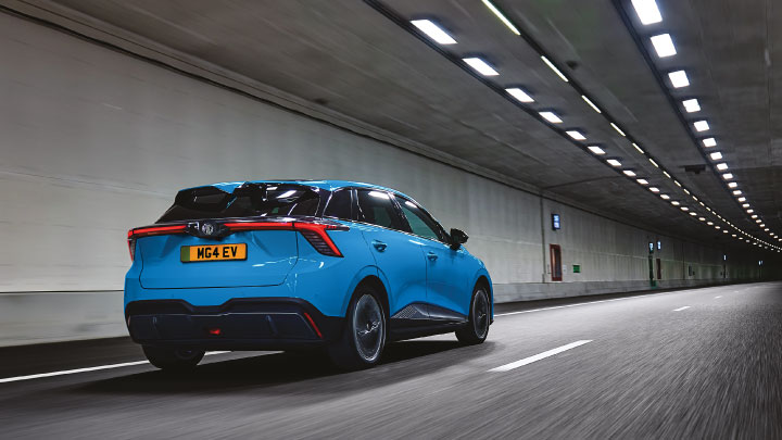 Rear Shot Of Blue MG4 EV Driving Through a Tunnel
