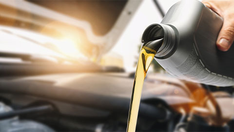 Car engine oil being filled